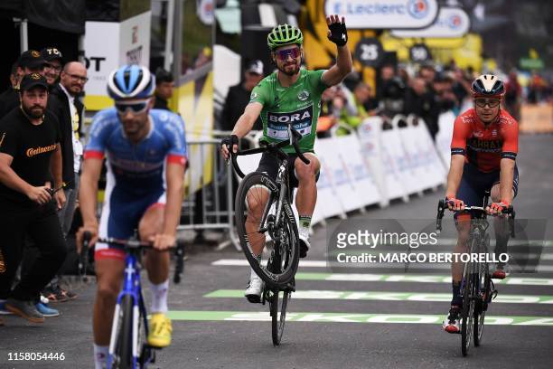 Slovakia's Peter Sagan performs a wheelie on the finish line of the twentieth stage of the 106th edition of the Tour de France cycling race between...