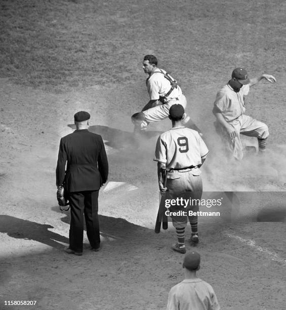 Floyd Vaughan, of the Pittsburgh Pirates, is safe at home plate on Van Robay's single to right field in the sixth inning of the fame with the...