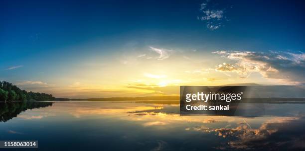 panoramic shot of sunrise over lake - panoramic lake stock pictures, royalty-free photos & images