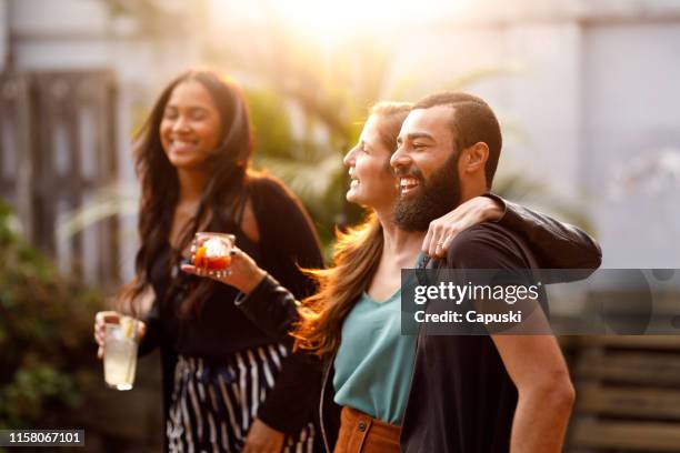 friends dancing at rooftop party - rooftop party stock pictures, royalty-free photos & images