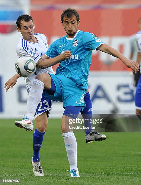 Luke Wilkshire of FC Dynamo Moscow battles for the ball with Danko Lazovic of FC Zenit St. Petersburg during the Russian Football League Championship...