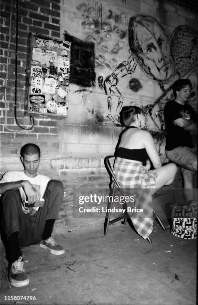 Riot Grrrl Convention attendees in courtyard behind Jabberjaw between bands’ sets in East Hollywood on July 29, 1995 in Los Angeles, California.