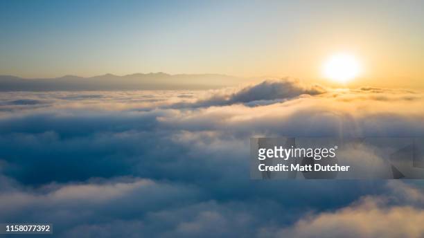 flying above the clouds - wolkengebilde stock-fotos und bilder