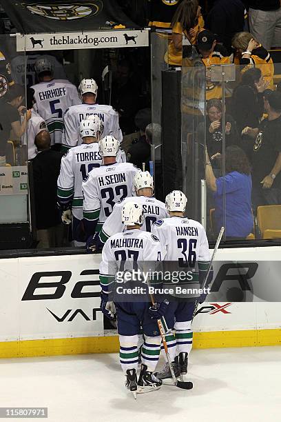 The Vancouver Canucks skate off the ice after being defeated by the Boston Bruins in Game Four of the 2011 NHL Stanley Cup Final at TD Garden on June...