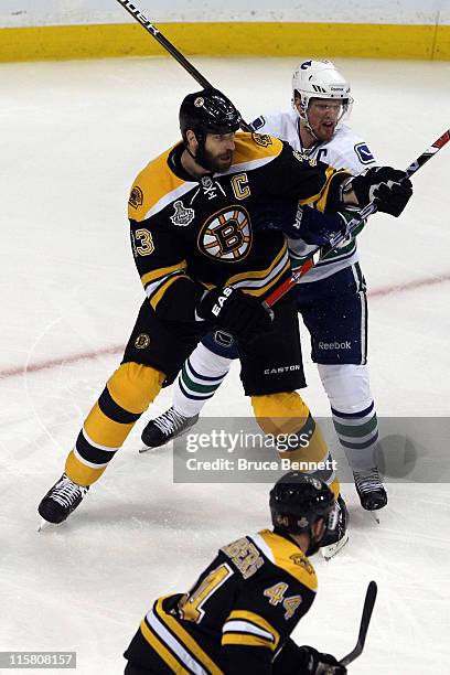 Zdeno Chara of the Boston Bruins fights with Henrik Sedin of the Vancouver Canucks during Game Four of the 2011 NHL Stanley Cup Final at TD Garden on...