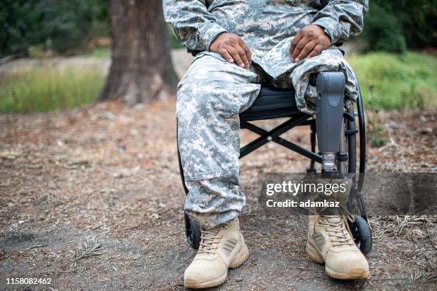 army veteran in wheelchair - prosthetic equipment stock pictures, royalty-free photos & images