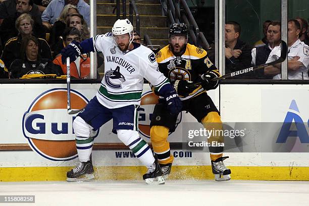 Mark Recchi of the Boston Bruins skates against Andrew Alberts of the Vancouver Canucks during Game Four of the 2011 NHL Stanley Cup Final at TD...