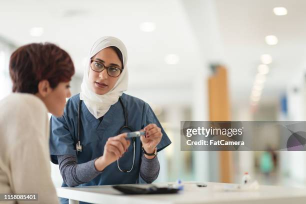 doctor meets with diabetic patient - injection pen stock pictures, royalty-free photos & images