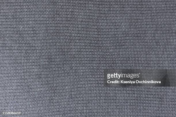 crumpled gray knitted blanket. soft and warm fabric crumpled in folds. texture for background or illustrations - maglione foto e immagini stock