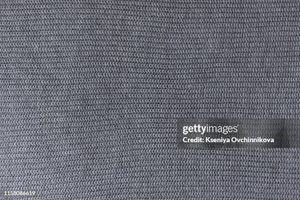 crumpled gray knitted blanket. soft and warm fabric crumpled in folds. texture for background or illustrations - sweater stock pictures, royalty-free photos & images