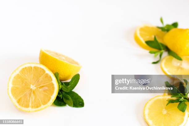 composition of delicious citrus fruit and green leaves on white background - corner peel stock-fotos und bilder