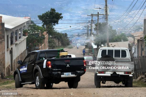 View of trucks of the Honduran state during a fumigation operation to combat Aedes aegypti mosquitoes, vector of the dengue fever, at the Nueva...