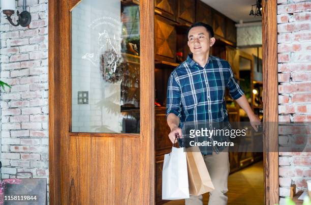customer with shopping bags leaving from store - leaving store stock pictures, royalty-free photos & images