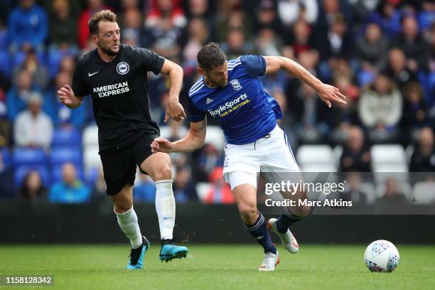 Dale Stephens of Brighton and Hove Albion in action with Lukas Jutkiewicz of Birmingham City during the Pre-Season Friendly match between Birmingham...