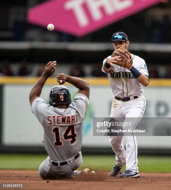 Second baseman Austin Nola of the Seattle Mariners turns a double play after forcing out Christin Stewart of the Detroit Tigers at second base on a...