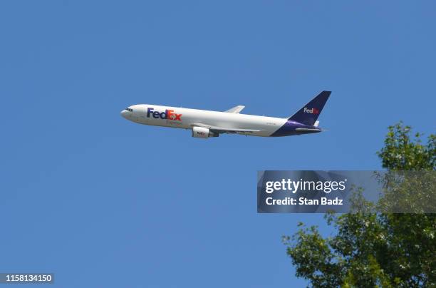 FedEx airplane flys over the course during the third round of the World Golf Championships-FedEx St. Jude Invitational at TPC Southwind on July 27,...