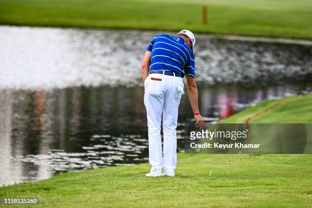 Justin Thomas takes a penalty drop after hitting in the water from the 18th tee during the third round of the World Golf Championships-FedEx St. Jude...