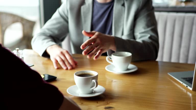 https://media.gettyimages.com/id/1158140371/video/closeup-of-two-anonymous-businessmen-talking-over-coffee-during-business-meeting-in-cafe.jpg?b=1&s=640x640&k=20&c=KCigPFvTzt3_j9h8hSyqL4aL6KzJ2gE2WTZecqrxYj8=