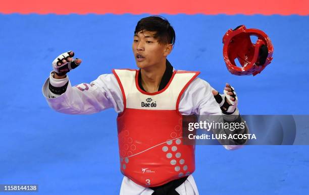 Taekwondo fighter David Kim celebrates after defeating Venezuela's Yohandri Granado in their Men's Under 58kg Bronze Medal combat during the Lima...