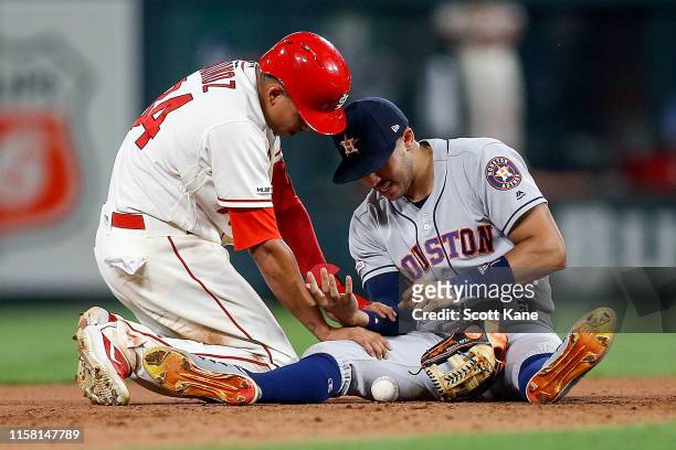 Yairo Munoz of the St. Louis Cardinals checks on Carlos Correa of the Houston Astros as Correa injured his arm while making an out against Munoz...
