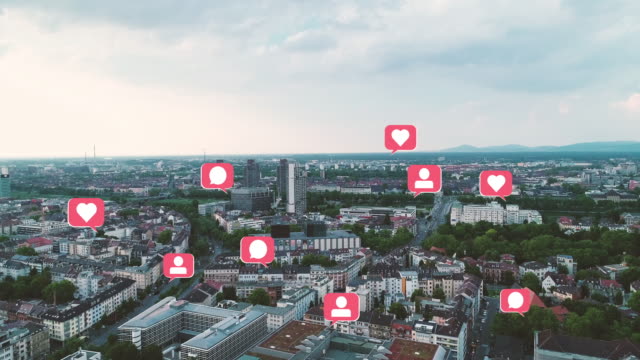 Technology Marketing Concept Aerial View of Cityscape with pop up Social Media Like Comment Follower Icons