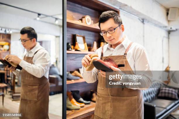 scarpe lucidanti per il proprietario del negozio di scarpe - polishing shoes foto e immagini stock