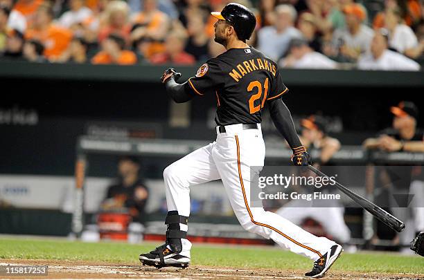 Nick Markakis of the Baltimore Orioles hits a grand slam in the second inning against the Tampa Bay Rays at Oriole Park at Camden Yards on June 10,...