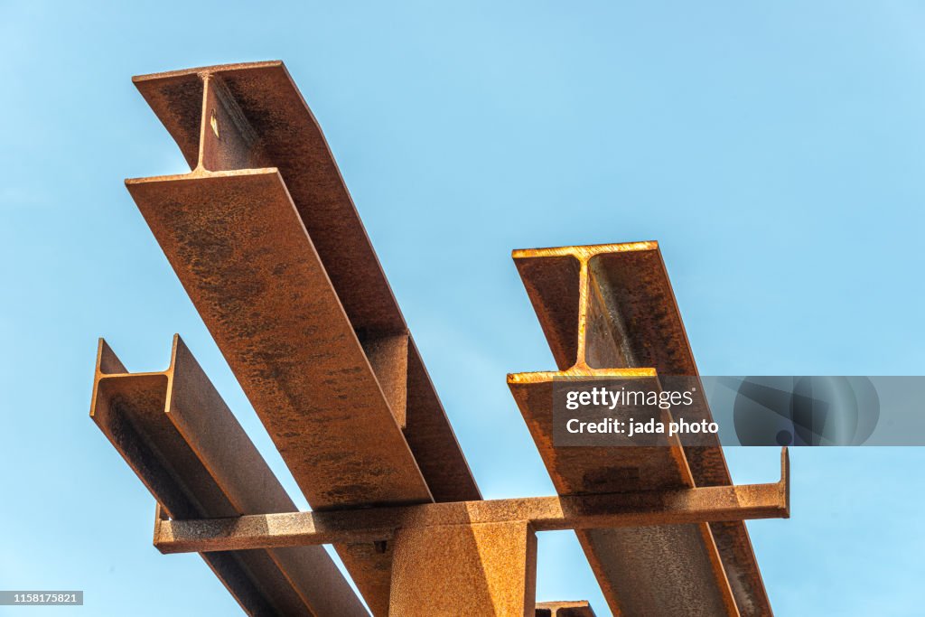 Rusty steel beams placed outside on a steel rack