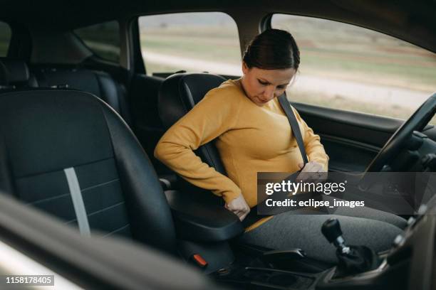 pregnant woman driving car - pregnant woman car stock pictures, royalty-free photos & images