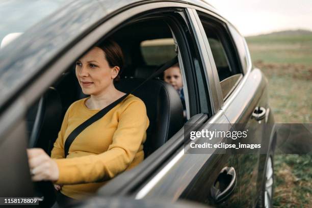 mother driving her son to home - mini van driving stock pictures, royalty-free photos & images