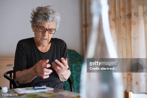 older woman living with diabetes - greek woman stock pictures, royalty-free photos & images