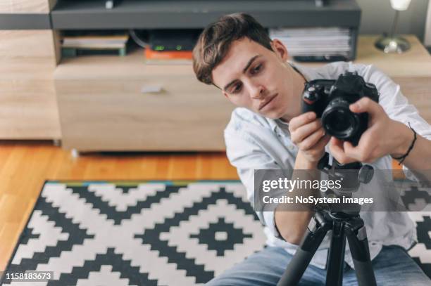 young male vlogger adjusting his gear - stars and strings 2019 stock pictures, royalty-free photos & images