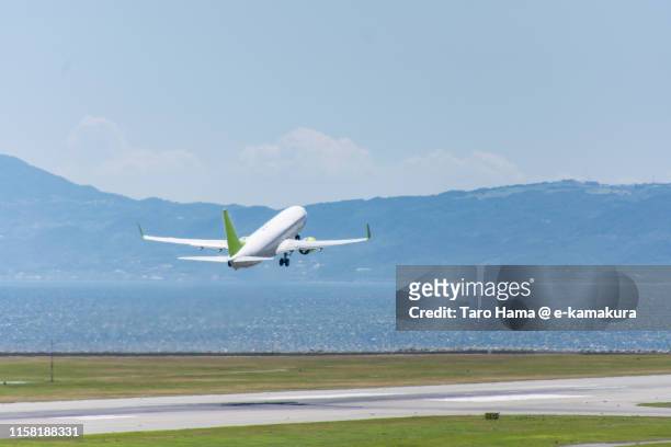 the airplane taking off the airport in kobe - jet tarmac stock pictures, royalty-free photos & images