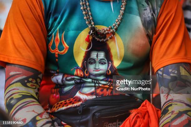 Image of Lord Shiva is seen on the T-Shirt of a devotee during the annual Kanwar yatra in Gurugram, Haryana