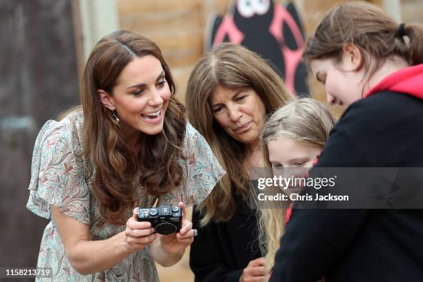 Catherine, Duchess of Cambridge joins a photography workshop for Action for Children, run by the Royal Photographic Society at Warren Park on June...