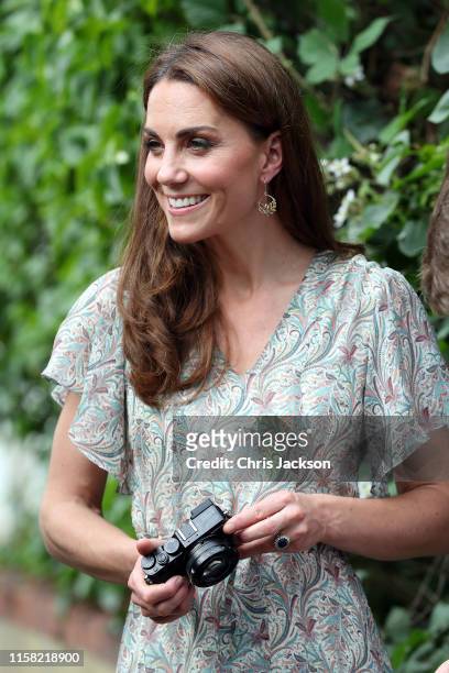 Catherine, Duchess of Cambridge joins a photography workshop for Action for Children, run by the Royal Photographic Society at Warren Park on June...