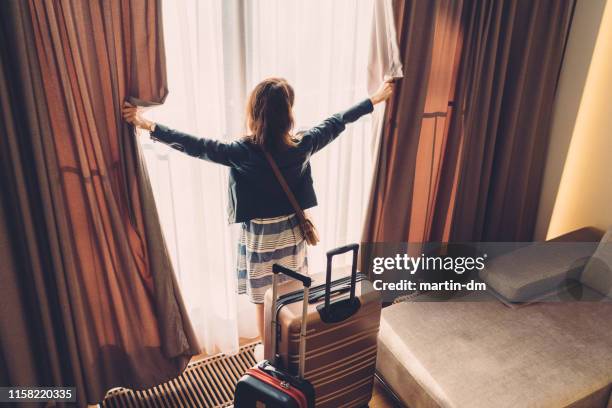 tourist woman just arriving in the hotel room - paris france hotel stock pictures, royalty-free photos & images