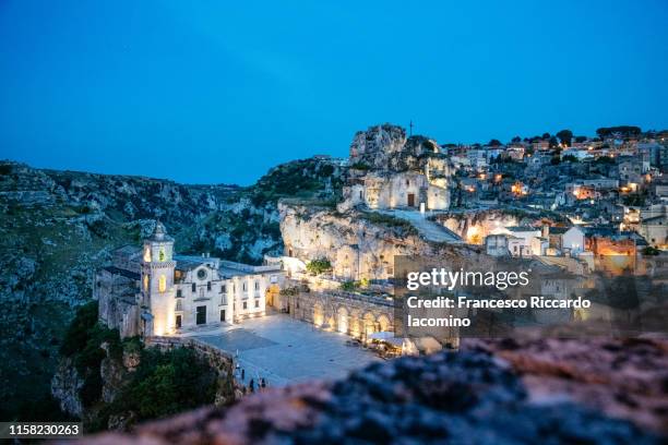 matera, basilicata, italy. scenic view by night of historic town with the church of the madonna de idris - matera stock pictures, royalty-free photos & images