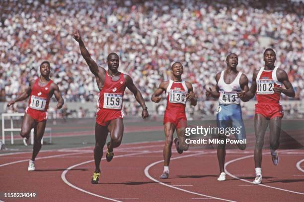 Left - right Desai Williams look across at Ben Johnson of Canada who holds his arm aloft in victory over Calvin Smith of the USA, Linford Christie of...