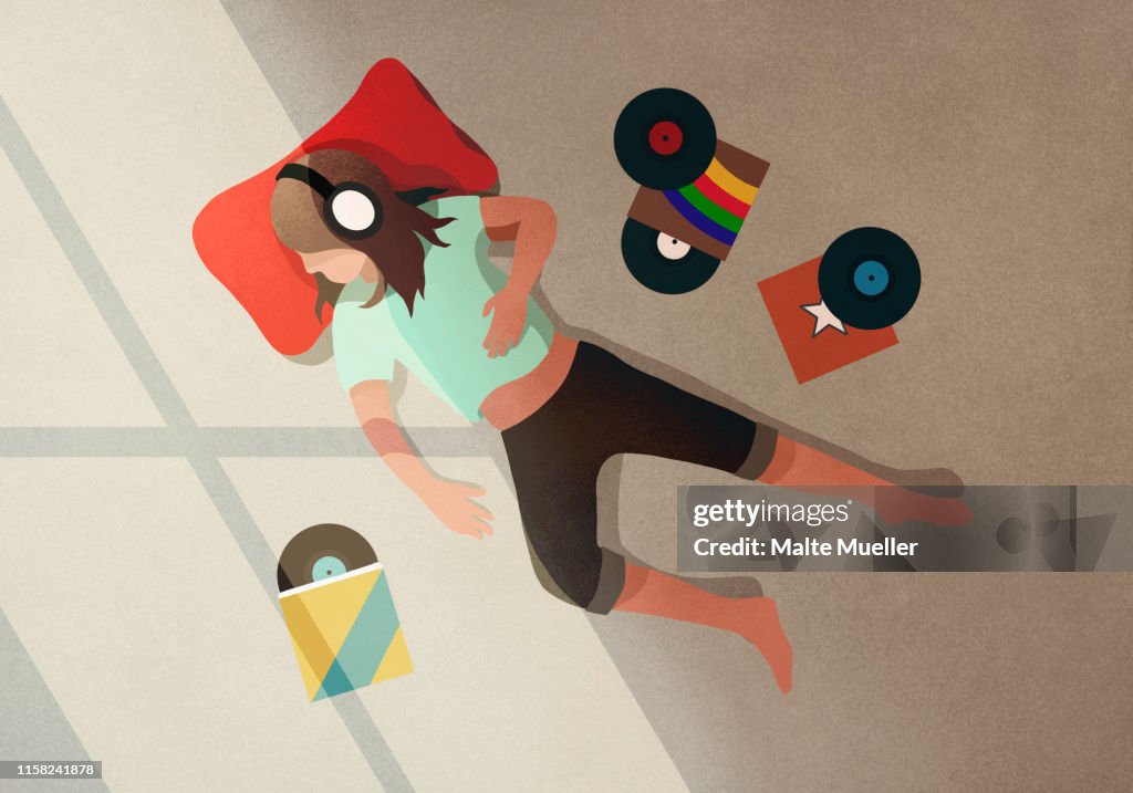 Carefree girl with headphones listening to records