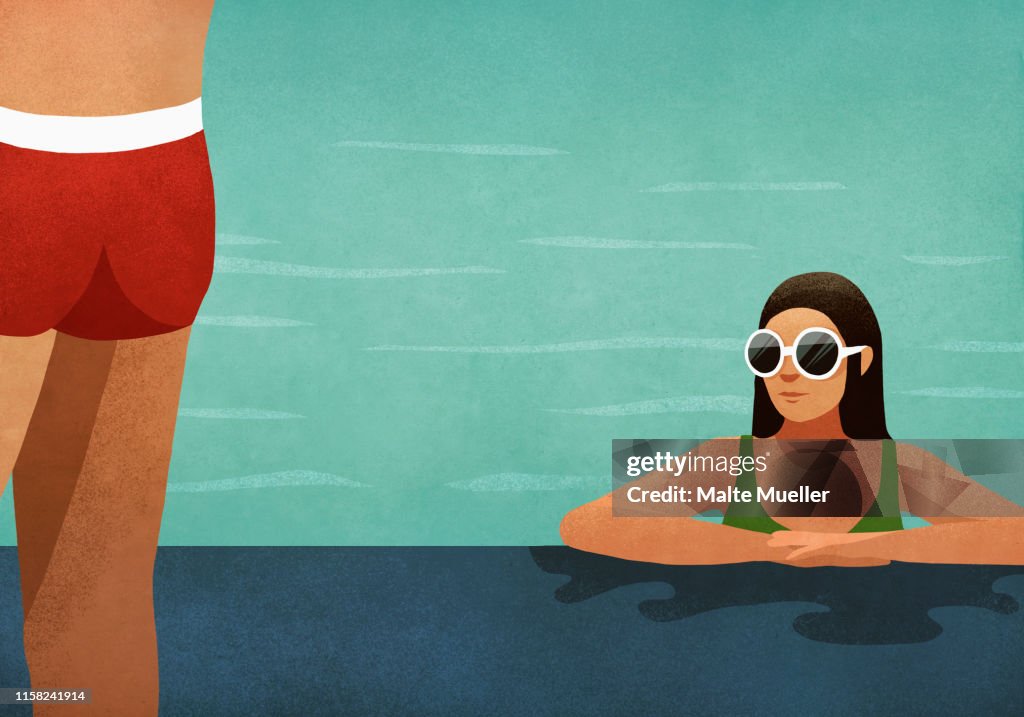 Woman in swimming pool checking out man