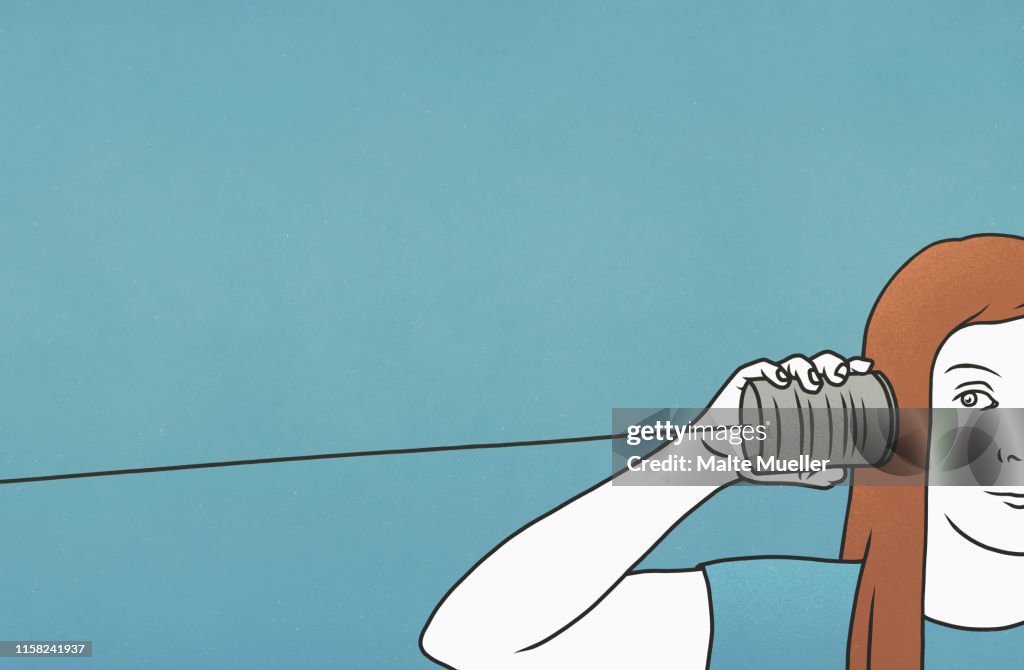 Woman listening in tin can telephone