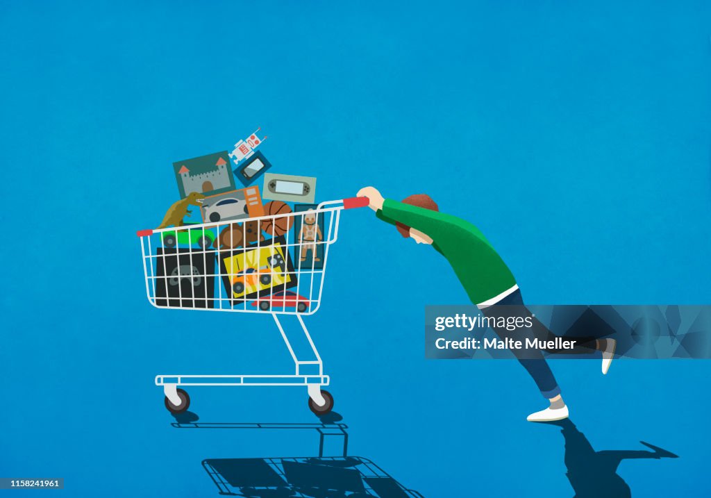 Boy pushing shopping cart full of toys