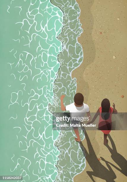 view from above couple holding hands, walking on ocean beach - strandurlaub stock-grafiken, -clipart, -cartoons und -symbole