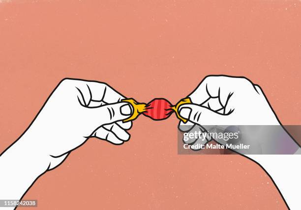 hands opening wrapped candy - eingewickelt stock-grafiken, -clipart, -cartoons und -symbole