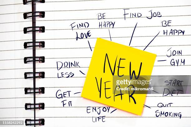 notebook spirals with note with new year 2020 - new years resolutions stock-fotos und bilder