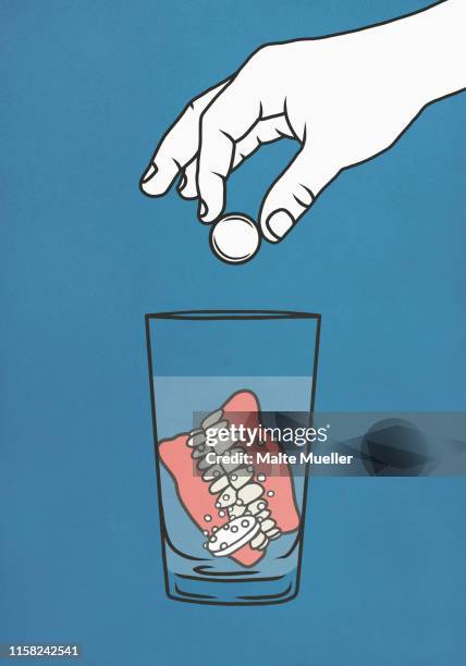 hand dropping denture cleaner tablets into glass of water with dentures - human teeth stock illustrations