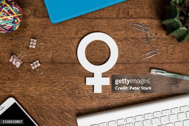 view from above paper female symbol on wooden desk - female symbol ストックフォトと画像