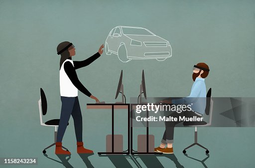 Computer programmers with virtual reality simulator glasses working in office Computer programmers with virtual reality simulator glasses working in office
