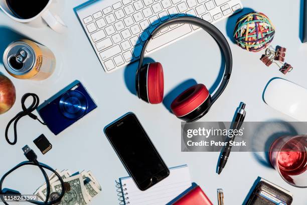 view form above headphones, smart phone, digital camera and office supplies on desk - smart communicate elevation view stockfoto's en -beelden